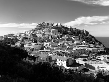 High angle view of townscape by sea against sky