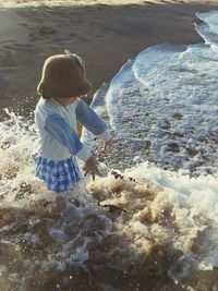 Rear view of woman standing on beach