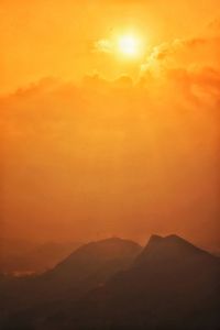 Scenic view of mountains against sky during sunset