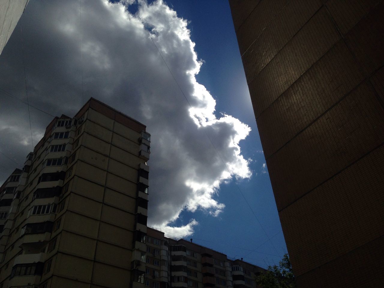 architecture, building exterior, built structure, low angle view, sky, cloud - sky, city, building, cloud, residential building, cloudy, residential structure, window, office building, modern, tower, tall - high, outdoors, day, no people