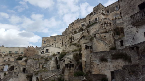 Low angle view of old building against cloudy sky