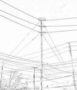 Low angle view of electricity pylon against sky