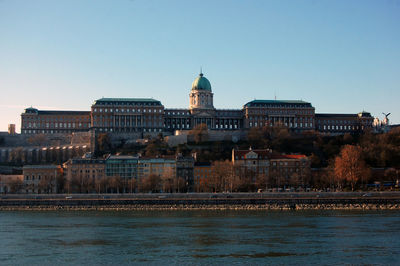 View of buildings against clear blue sky