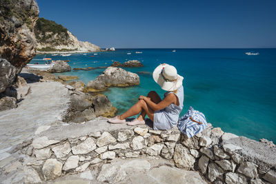 Full length of woman looking at sea against sky