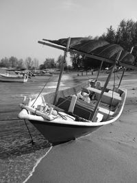 High angle view of woman sitting on boat against sky