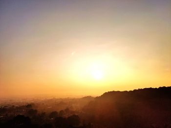 Scenic view of silhouette mountains against sky during sunset