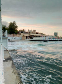 Scenic view of sea and buildings against sky