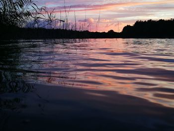 Scenic view of lake against sky at sunset