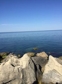 Scenic view of sea against clear blue sky