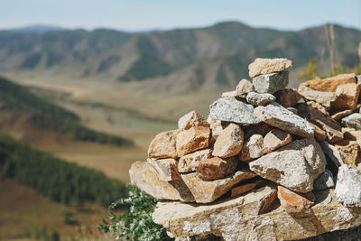 Pile of stones pyramid on background of the altai mountains