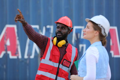 Side view of man with arms raised