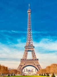 Low angle view of eiffel tower against cloudy sky