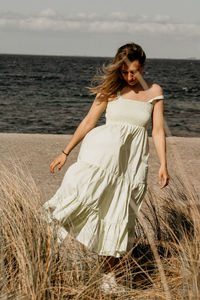 Young woman standing at beach