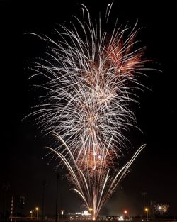 Low angle view of firework display against sky at night