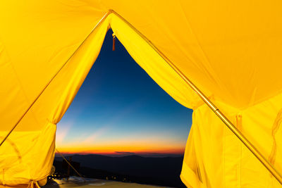 Low angle view of tent against sky during sunset