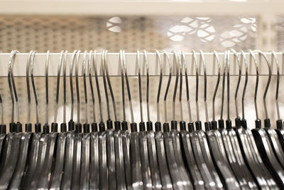 Cloth hanger hanging on display inside clothing shop outlet