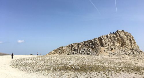 Scenic view of rocks on beach against sky