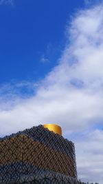 Low angle view of building against cloudy sky