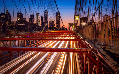 Light trails on street against sky at night
