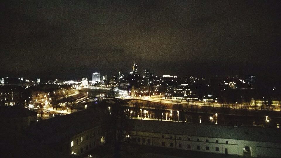 VIEW OF ILLUMINATED CITYSCAPE AT NIGHT