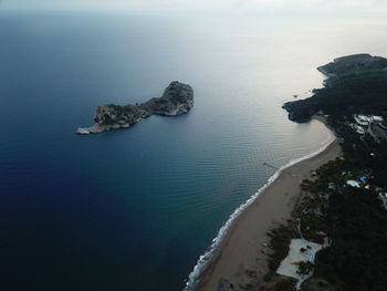 High angle view of rocks on beach against sky