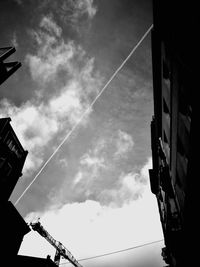 Low angle view of vapor trails against sky