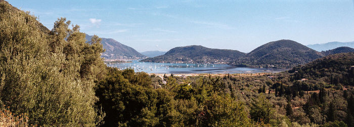 Scenic view of sea and mountains against sky