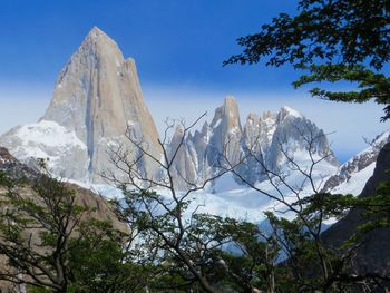 Low angle view of snowcapped mountains against sky