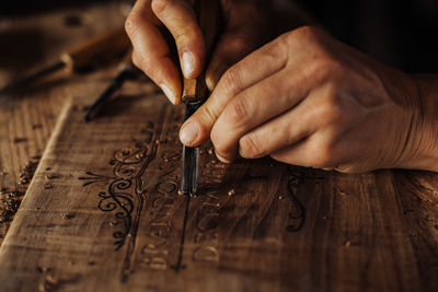 Midsection of person working on wood