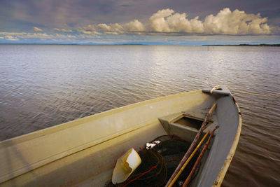 Boat moored in lake against sky