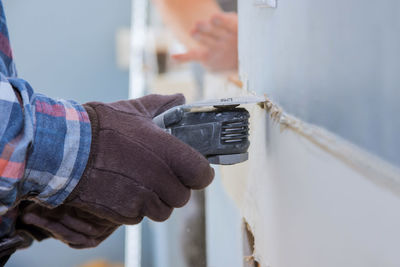 Close-up of man working on metal