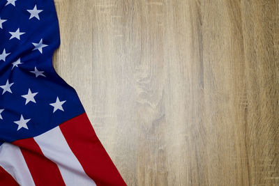 Close-up of american flag on wooden floor