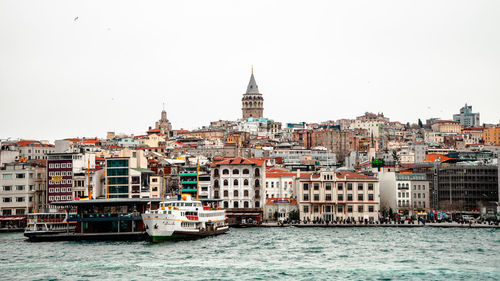 View of buildings and a ferry in galata by the bosphorus