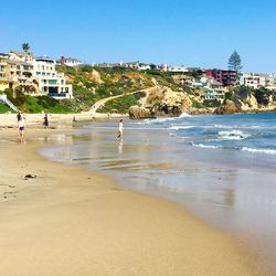 Scenic view of beach against buildings in city