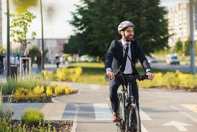 Portrait of young woman riding bicycle on street