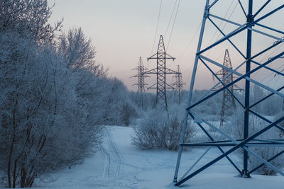 Low angle view of electricity pylon against clear sky