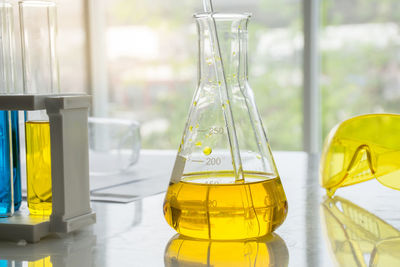 Yellow flask on table in laboratory