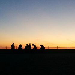 Silhouette of people at sunset