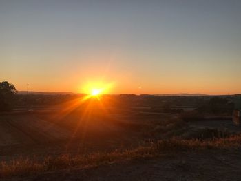 Scenic view of field against sky during sunset