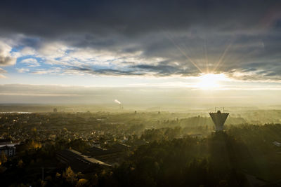 Aerial view of buildings in city during sunset