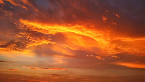 Low angle view of dramatic sky during sunset