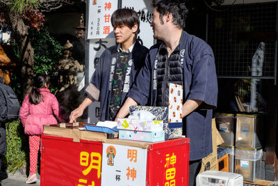 People at kanda shrine on sunny day