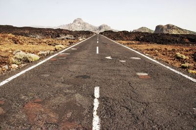 Road by mountain against clear sky