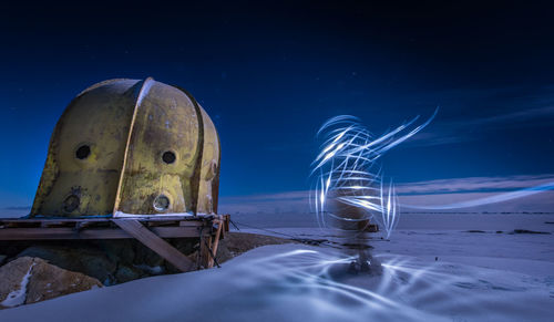 Digital composite image of ship on sea against sky at night