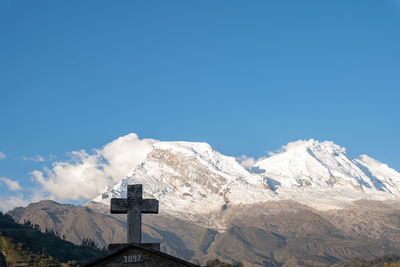 Snow-capped huascaran mountain seen from the cemetery of the town called yungay in huaraz, peru.