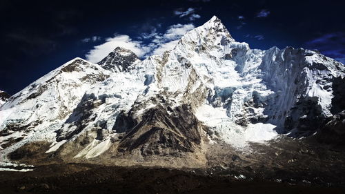 Low angle view of snowcapped mountain against sky