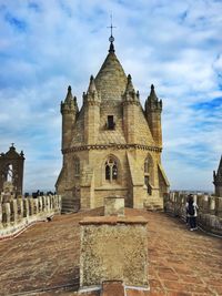 Low angle view of church against cloudy sky