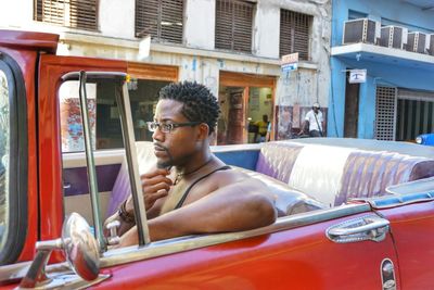 Man driving vintage car in city