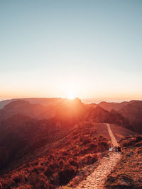 Scenic view of landscape against clear sky during sunset