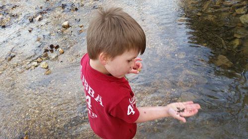 High angle view of boy playing in water at beach